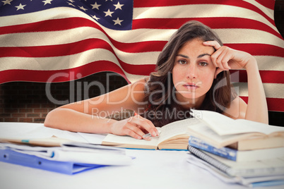 Composite image of bored student doing her homework