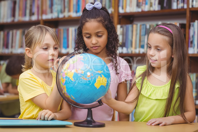 Pupils in library with globe