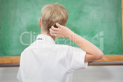 Puzzled student looking at blackboard