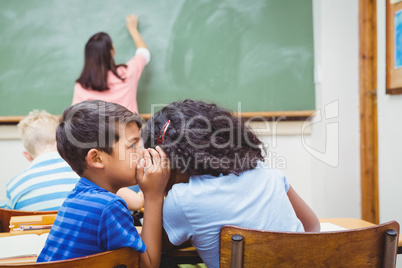 Student whispering into another students ear