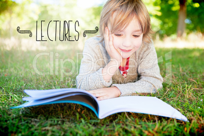 Lectures against cute little boy reading in park