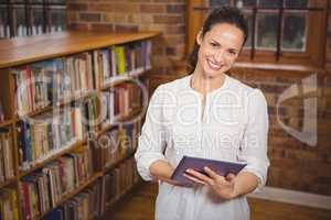 Smiling teacher holding a tablet in her hands