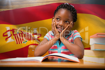 Composite image of pupil sitting at her desk