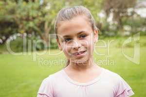 A Smiling kid standing outside