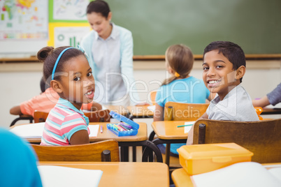 Pupils smiling at camera during class Pupils smiling at camera during class