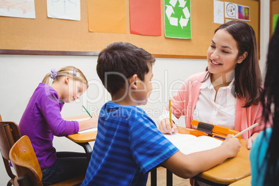 Happy teacher helping her students