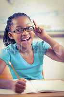 Cute pupil having an idea in a classroom