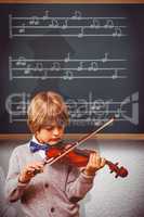 Composite image of cute little boy playing violin