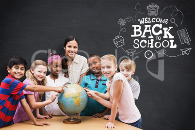 Composite image of cute pupils and teacher looking at globe in l