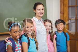 Teacher and pupils smiling in classroom