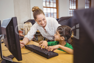 Teacher showing student how to use a computer