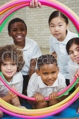 Students looking through hula hoops