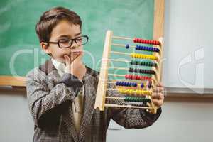 Pupil dressed up as teacher holding abacus