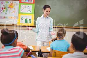 Pupils listening to their teacher at chalkboard