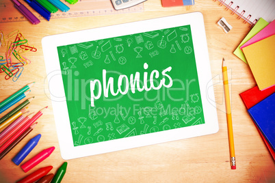 Phonics against students desk with tablet pc