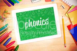 Phonics against students desk with tablet pc