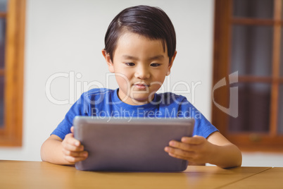 Cute pupil in class using tablet pc