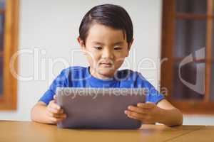 Cute pupil in class using tablet pc