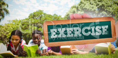 Exercise against children lying on grass and reading books