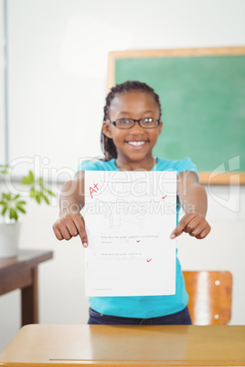 Proud pupil showing test result to camera