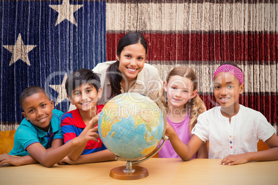 Composite image of cute pupils and teacher looking at globe in l