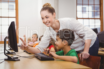 Teacher helping a student using a computer