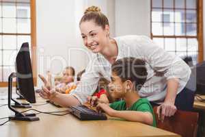 Teacher helping a student using a computer