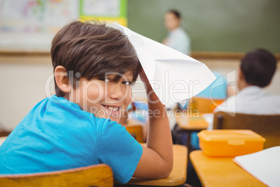 Pupil about to throw paper airplane