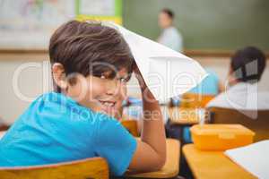 Pupil about to throw paper airplane