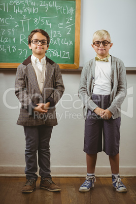 Smiling pupils dressed up as teachers in a classroom