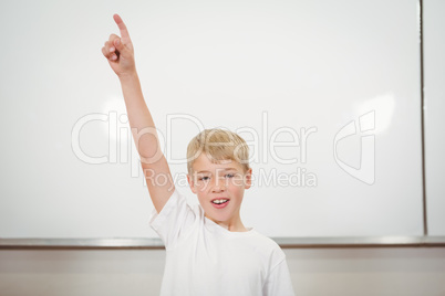 Student raising his hard in the classroom