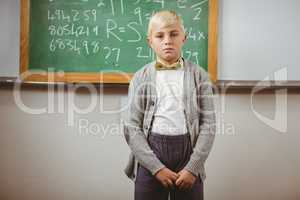 Pupil dressed up as teacher in front of chalkboard