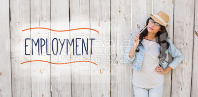 Employment against pretty brunette thinking and smiling