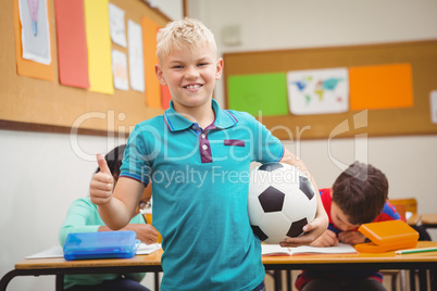 Smiling student holding a football