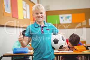 Smiling student holding a football