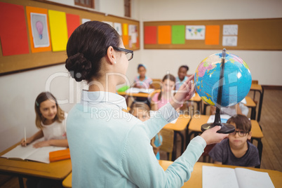 Teacher showing pupils a globe