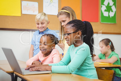 Pupils using a laptop in class