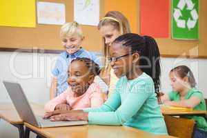 Pupils using a laptop in class