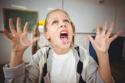 Shocked pupil sitting at her desk in a classroom