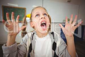 Shocked pupil sitting at her desk in a classroom