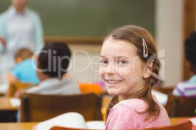 Pupil smiling at camera during class