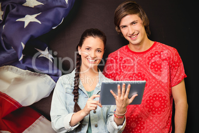 Composite image of smiling classmates with tablet pc