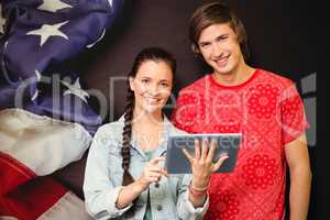 Composite image of smiling classmates with tablet pc