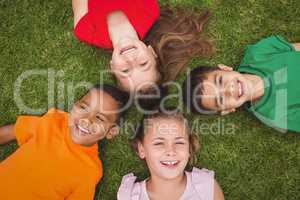 Smiling pupils lying on the ground