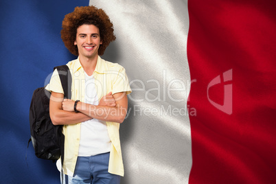 Composite image of young man with arms crossed in office corrido