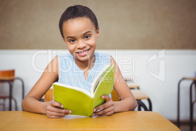 Smiling student reading a book