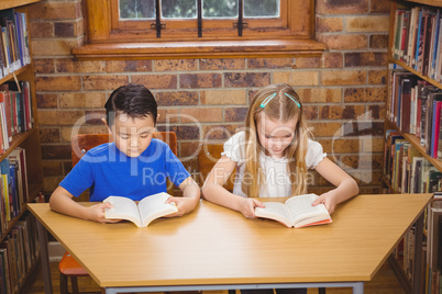 Students reading books while sitting down