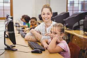 Teacher helping a student using a computer