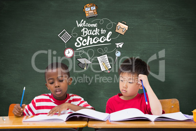 Composite image of cute pupils writing at desk in classroom