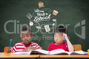 Composite image of cute pupils writing at desk in classroom